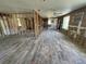 Open-concept living room with modern flooring and exposed framing for redesign and customization at 204 162Nd Ave, Redington Beach, FL 33708