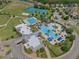 Aerial view showcases community pools, lush landscaping, clubhouse, and surrounding homes at 21046 Passive Porch Dr, Land O Lakes, FL 34637