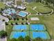 Expansive aerial view of community amenities including pools, tennis, and basketball courts near a park at 21046 Passive Porch Dr, Land O Lakes, FL 34637