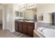 Bathroom featuring dual sinks, vanity, bathtub, and shower at 21046 Passive Porch Dr, Land O Lakes, FL 34637