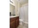 Bathroom with a modern vanity, granite countertop, and a pristine white shower curtain at 21046 Passive Porch Dr, Land O Lakes, FL 34637
