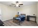 Bedroom with ceiling fan and a large window offering natural light at 21046 Passive Porch Dr, Land O Lakes, FL 34637