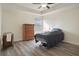 Bedroom featuring sleek flooring, a ceiling fan, and a window allowing for natural light at 21046 Passive Porch Dr, Land O Lakes, FL 34637