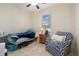 Cozy bedroom with ceiling fan, window, and comfortable furnishings at 21046 Passive Porch Dr, Land O Lakes, FL 34637