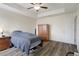Bedroom with ceiling fan, wood floors, and dresser at 21046 Passive Porch Dr, Land O Lakes, FL 34637