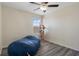 Bedroom with wood-look floors, ceiling fan, and natural light at 21046 Passive Porch Dr, Land O Lakes, FL 34637