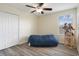 Bedroom with wood-look floors, ceiling fan, and natural light at 21046 Passive Porch Dr, Land O Lakes, FL 34637