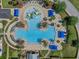 Overhead view of community pool with zero entry, waterslides, and lounge areas at 21046 Passive Porch Dr, Land O Lakes, FL 34637