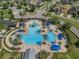 Overhead view of community pool with zero entry, waterslides, and lounge areas at 21046 Passive Porch Dr, Land O Lakes, FL 34637