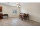 Dining area featuring tile flooring, a ceiling fan, and a neutral color palette for a warm, inviting feel at 21046 Passive Porch Dr, Land O Lakes, FL 34637