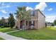 Well-maintained two-story home with stone-accented entry, neat landscaping, and inviting curb appeal at 21046 Passive Porch Dr, Land O Lakes, FL 34637