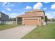 Two-story home with a two-car garage, screened lanai, and well-maintained lawn at 21046 Passive Porch Dr, Land O Lakes, FL 34637