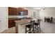 Open kitchen view, including stainless steel appliances, granite countertops, island, and dining area at 21046 Passive Porch Dr, Land O Lakes, FL 34637