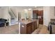 Open kitchen with stainless steel appliances and a center island with granite countertop at 21046 Passive Porch Dr, Land O Lakes, FL 34637