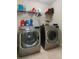 Well-organized laundry room featuring modern LG washer and dryer with wire shelving at 21046 Passive Porch Dr, Land O Lakes, FL 34637