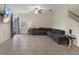 Open living room with a large sectional sofa, tile floors, and a sliding glass door for plenty of natural light at 21046 Passive Porch Dr, Land O Lakes, FL 34637