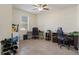 Spacious office with abundant natural light, equipped with desks, tiled floor, and ample space for work or hobbies at 21046 Passive Porch Dr, Land O Lakes, FL 34637