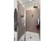Tiled shower with glass door and shower head at 21046 Passive Porch Dr, Land O Lakes, FL 34637
