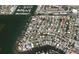 An aerial view shows the neighborhood featuring waterfront properties and a marina at 2488 Del Rio Way, Dunedin, FL 34698