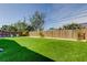 A spacious backyard features a lush green artificial lawn and a wooden fence in a tranquil setting at 2488 Del Rio Way, Dunedin, FL 34698
