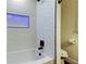 Bathroom showing a tiled shower with a built-in shelf and a white tub at 2488 Del Rio Way, Dunedin, FL 34698