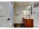Modern bathroom featuring a wood vanity with double sinks and a tiled shower at 2488 Del Rio Way, Dunedin, FL 34698