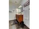 Bathroom featuring a wood vanity with double sinks, hexagon tile floor, and sleek lighting at 2488 Del Rio Way, Dunedin, FL 34698