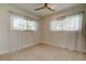 Bright bedroom with a ceiling fan, speckled floors, and sheer curtains at 2488 Del Rio Way, Dunedin, FL 34698