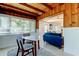 Bright dining area featuring wood-paneled ceilings, a modern table set, and an opening to the living room at 2488 Del Rio Way, Dunedin, FL 34698