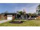 Charming single-story home featuring a well-manicured lawn, modern design, and an attached one car garage at 2488 Del Rio Way, Dunedin, FL 34698