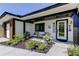 Welcoming home exterior featuring a cozy sitting area, lush landscaping, and modern design at 2488 Del Rio Way, Dunedin, FL 34698