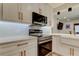 Updated kitchen featuring stainless appliances, under cabinet lighting, and modern hardware at 2488 Del Rio Way, Dunedin, FL 34698