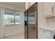 Modern kitchen with stainless refrigerator next to a window with natural light at 2488 Del Rio Way, Dunedin, FL 34698