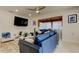 Cozy living room featuring modern furniture, a ceiling fan, and shiplap accent wall at 2488 Del Rio Way, Dunedin, FL 34698