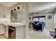 Open-concept layout with kitchen view into a cozy living room featuring modern furnishings at 2488 Del Rio Way, Dunedin, FL 34698