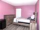 This cozy bedroom features a wooden frame bed and plenty of room at 25417 Lexington Oaks Blvd, Wesley Chapel, FL 33544