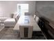 Elegant dining area with a modern table, stylish chairs, and sophisticated decor, adjacent to a cozy living space at 25417 Lexington Oaks Blvd, Wesley Chapel, FL 33544