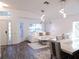 Bright open-plan living room features modern lighting, wood-look flooring, and neutral decor at 25417 Lexington Oaks Blvd, Wesley Chapel, FL 33544