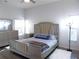 This comfortable main bedroom features a king bed, light walls, and natural light at 25417 Lexington Oaks Blvd, Wesley Chapel, FL 33544