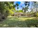 Expansive backyard featuring lush lawn and screened in lanai, providing an ideal space for outdoor enjoyment at 2558 Arborwood Dr, Valrico, FL 33596