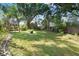 Spacious backyard with lush lawn, mature trees, and a tranquil setting, perfect for outdoor activities at 2558 Arborwood Dr, Valrico, FL 33596