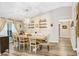 Bright dining room with wood-style floors, large table, and natural light from the window at 2558 Arborwood Dr, Valrico, FL 33596