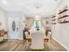 Well-lit dining area featuring modern lighting, wood floors and shelving at 2558 Arborwood Dr, Valrico, FL 33596