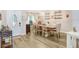 Bright dining room with wood-style floors, elegant table, and plenty of natural light at 2558 Arborwood Dr, Valrico, FL 33596