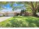 Charming single-story home with mature trees, manicured lawn, and a two-car garage at 2558 Arborwood Dr, Valrico, FL 33596