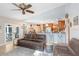 Open-concept living room connecting to the kitchen, featuring comfortable seating and a breakfast bar at 2558 Arborwood Dr, Valrico, FL 33596