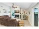 Cozy living room with a fireplace, ceiling fan, and comfortable seating; perfect for relaxing and entertaining at 2558 Arborwood Dr, Valrico, FL 33596