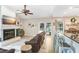 Open concept living room with fireplace, view to the screened patio, and a bar area with seating at 2558 Arborwood Dr, Valrico, FL 33596