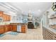 Open-concept kitchen and living area with stainless appliances, hardwood flooring, and a cozy fireplace at 2558 Arborwood Dr, Valrico, FL 33596