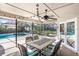 Screened-in patio with dining table, chairs, and view of the backyard pool and garden area at 2558 Arborwood Dr, Valrico, FL 33596